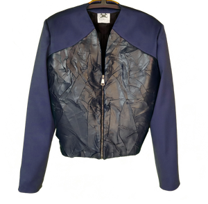 Out of the water is a jacket with Vegan Leather worked to simulate wet and wrinkled fabric texture.  100% pure wool Made in Italy   100% Vegan Leather  zip closure  Made in Italy  the model is 1,84cm and is wearing size 48 IT.