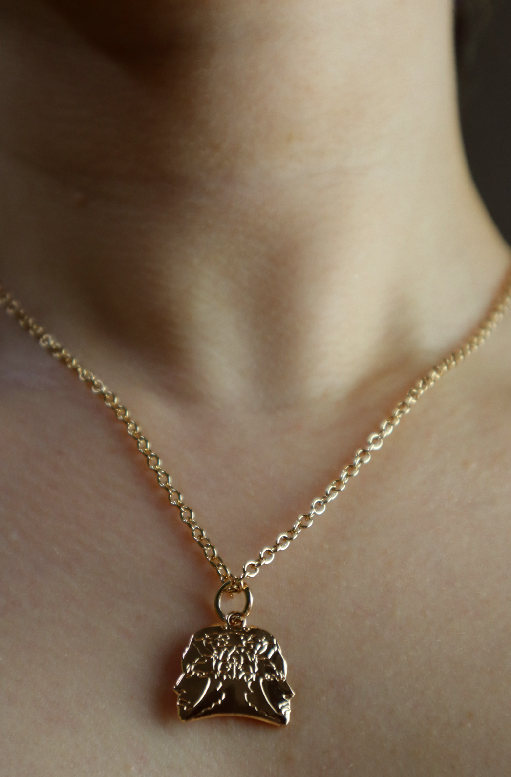 girl wearing a light gold plated necklace