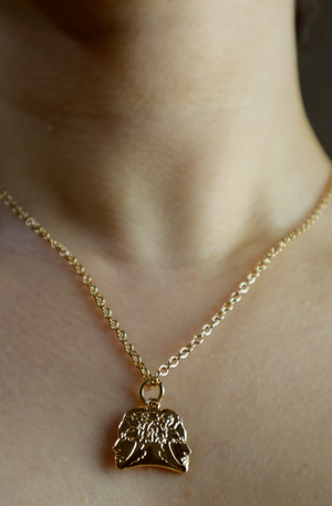 girl wearing a light gold plated necklace